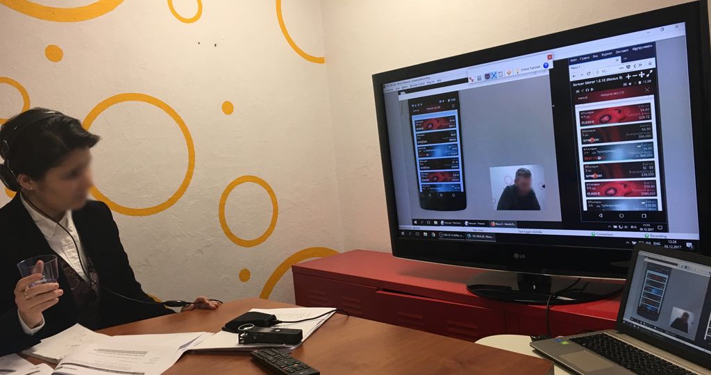 Picture of interpreter watching research via a monitor
